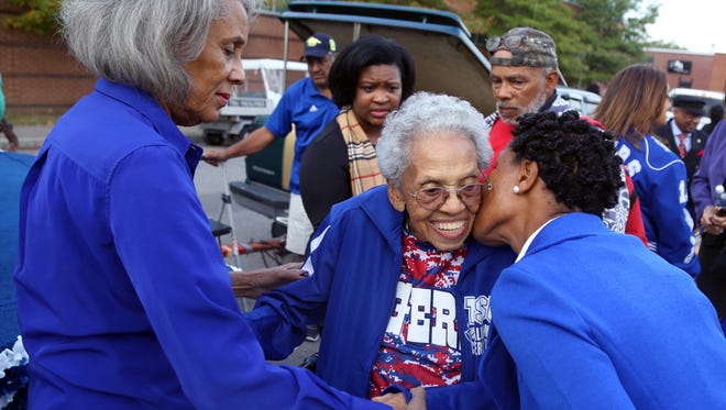 101 year-old Burnece Walker Brunson, center, a former TSU cheerleader and grand marshal of the 2016 Homecoming Parade, receives a kiss on the cheek as her daughter Carol Day helps her get on the float prior to the start of the parade on Saturday October 15, 2016.