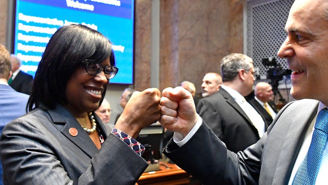 Kentucky Gov. Matt Bevin, right, and Kentucky Lt. Governor Jenean Hampton bump fists as they await the swearing in of Jeff Hoover as Speaker of the Kentucky House of Representatives Tuesday Frankfort.