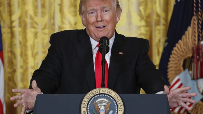 President Donald Trump speaks during a news conference in the East Room of the White House on Thursday.