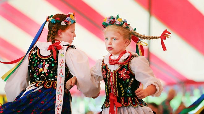 Members of the dance ensemble Zajaczek perform at the American Polish Century Club during the American-Polish Festival in Sterling Heights on Sunday. Some festival dancers wore costumes that had been made by hand in Poland.