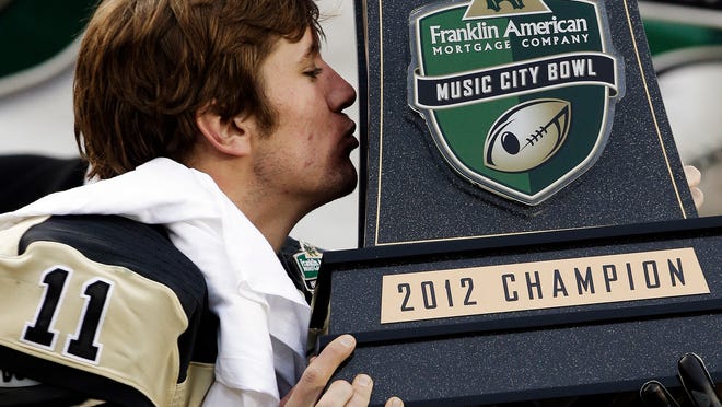 Vanderbilt quarterback Jordan Rodgers kisses the trophy after defeating North Carolina State 38-24 in the Music City Bowl on Dec. 31, 2012, in Nashville.