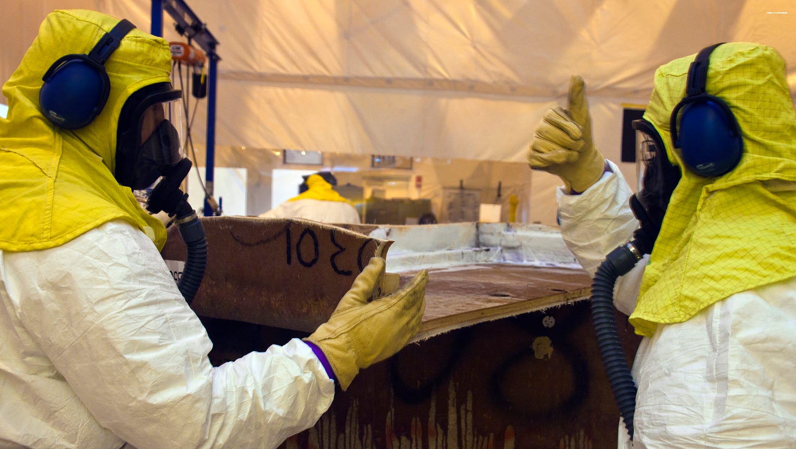 Crews repackage waste from a fiberglass reinforced plywood box into a container that can be shipped to the Waste Isolation Pilot Plant near Carlsbad, N.M.
