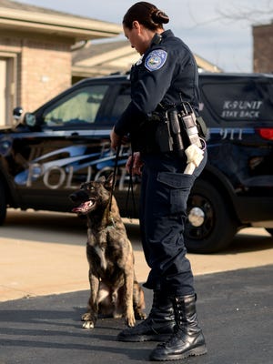Officer Jennifer Sly stands with police dog Knight. The two assisted in an investigation into a boy's claim that a man tried to grab him.