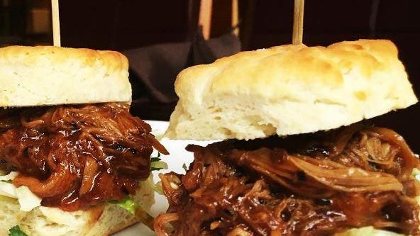 Knuckles Sports Bar features dishes like the blueberry chipotle pulled pork sandwiches.