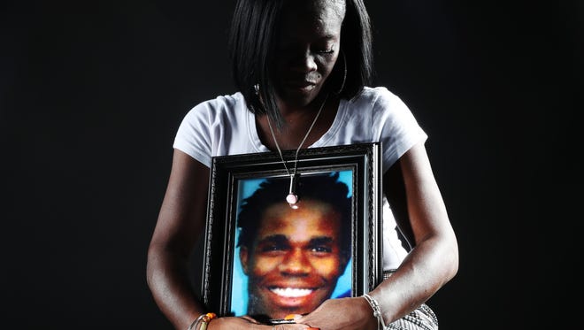 Camelia Schley poses with a photo of her murdered son Angelo Gary. Gary was murdered in 2006.  Schely is bringing Bullets4Life to Fort Myers. The idea is for people to donate bullets which are then taken apart and made into jewelry.  