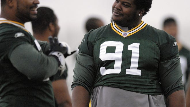 Packers' Cullen Jenkins (77), left, and Justin Harrell (91), right, visit with each other during minicamp inside the Don Hutson Center on Wednesday, June 18, 2008. Photo by Evan Siegle/Press-Gazette