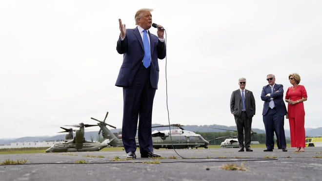 President Donald Trump speaks to a crowd at Asheville Regional Airport, Monday, Aug. 24, 2020, in Fletcher, N.C. From left, Trump, House Minority Leader Kevin McCarthy of Calif., chief of staff Mark Meadows and his wife Debbie Meadows.