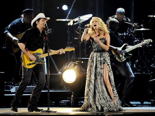 Co-hosts Brad Paisley, left, and Carrie Underwood perform