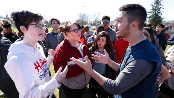 Elaine Flores, left, and Jared Baumann engage in a