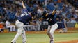 Aug. 5: Brewers' Hernan Perez is congratulated by third