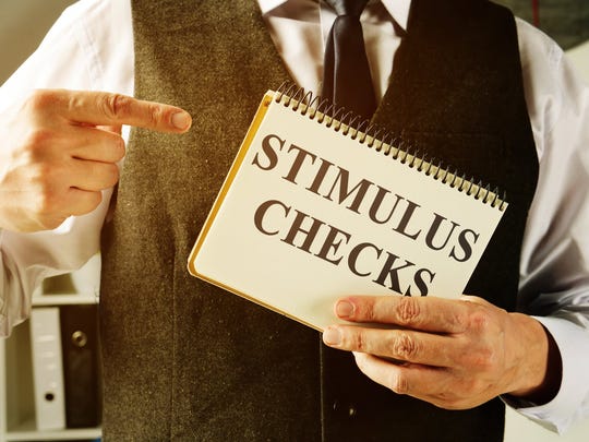A man holds information about stimulus checks.