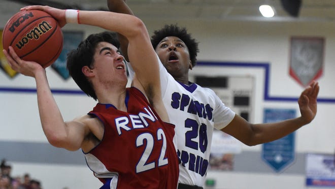 Spanish Springs' Cordell Stinson covers Reno's Timmy Damon as he goes up to shoot in Tuesday's game at Spanish Springs.