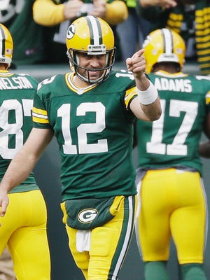 Green Bay Packers quarterback Aaron Rodgers celebrates a touchdown pass to Davante Adams (17) against the Carolina Panthers.
