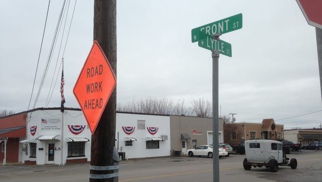 The "ROAD WORK AHEAD" sign warns motorists that crews are working to improve Lytle Street near Broad Street. The upgrades include a reconfigured intersection at Lytle and Broad with a traffic light and crosswalks and a roundabout at the non-perpendicular intersection of Lytle and College Street.