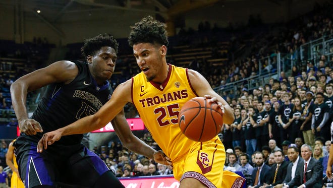 USC's Bennie Boatwright (right) drives past  Washington's Noah Dickerson in the second half Wednesday. Boatwright, playing for the first time in two months, scored a game-high 23 points as the Trojans won 82-74.