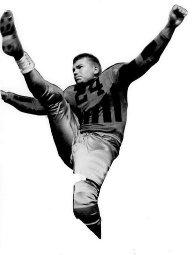 Undated photo - Nile Kinnick kicking pose in his Iowa