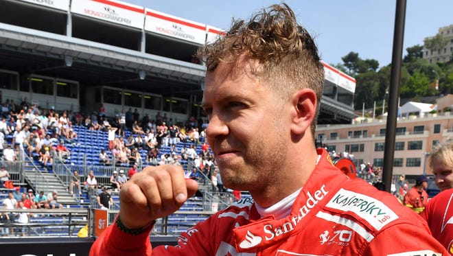 Ferrari's Sebastian Vettel reacts in the pits after a strong second practice session Thursday for the Monaco Grand Prix.