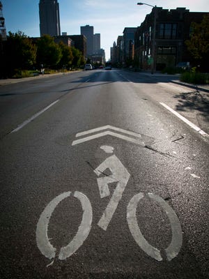 Bike-sharing lanes on Locust Street and Grand Avenue in downtown Des Moines, shown in 2013, feature a biker logo and arrow.