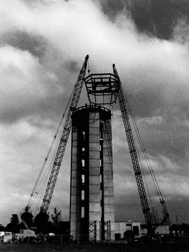 John B. Pike crew lifts the 14-ton, 20-ft-tall operations center frame to the top of the control tower at the Rochester Monroe County Airport. (staff photo, 1981)