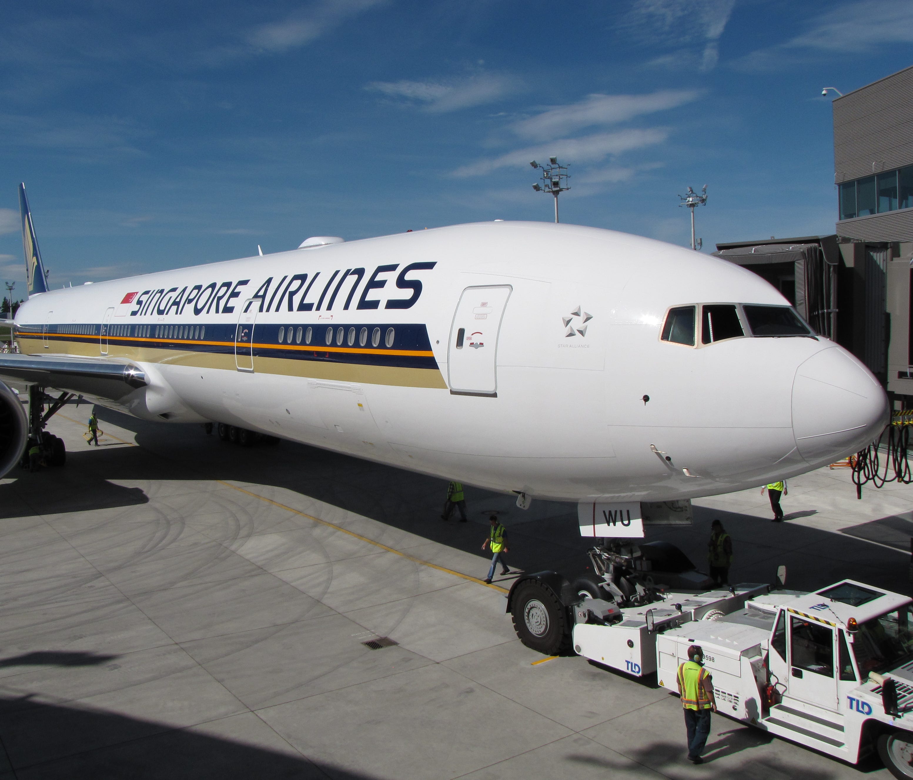 Seen here in a photo from September 2013 is a shot of the first Singapore Airlines Boeing 777-300ER to be configured with its all-new interior at the gate at Boeing's Everett Delivery Center.