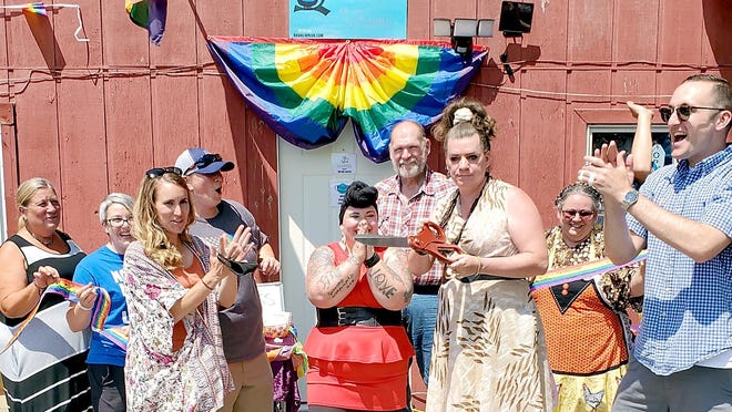 First Ward Councilwoman Emily Rissman and chamber of commerce director Cayden Sparks clap s Bekah Hampton and Chris Robin Boger cut the rainbow ribbon for "Branch Pride Community Reosurces Center" Sunday afternoon.