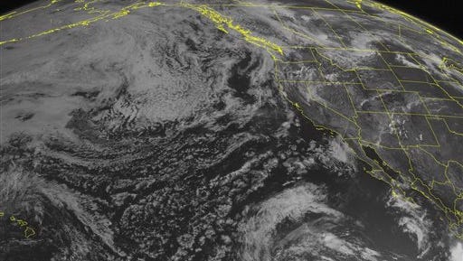 This NOAA satellite image taken Sunday, July 12, 2015 at 1:00 p.m. shows a trough of low pressure along the Pacific Northwest Coastline producing showers. Another trough of low pressure across the Intermountain West and Central Rockies will produce showers and thunderstorms. An area of low pressure along a stalled front will bring showers and thunderstorms to the Central and Northern Plains. Some of these storms could be severe with large hail and damaging winds. Mainly dry weather is expected across most of Texas under an area of high pressure. (Weather Underground via AP)