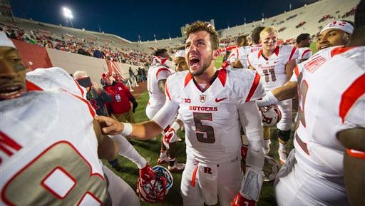 Rutgers quarterback Chris Laviano (5) celebrates with his teammates after defeating Indiana in an NCAA college football game, Saturday, Oct. 17, 2015, in Bloomington, Ind. Rutgers won 55-52 with a field goal as time expired. (AP Photo/Doug McSchooler)