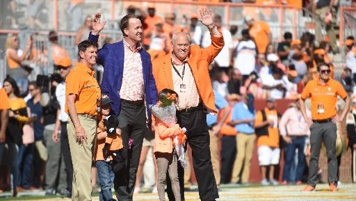Former Tennessee quarterback Peyton Manning was honored before Saturday's game at  Neyland Stadium with a presentation by former coach Phillip Fulmer and UT athletic director Dave Hart. Also pictured are Manning's children, twins Marshall and Mosley.