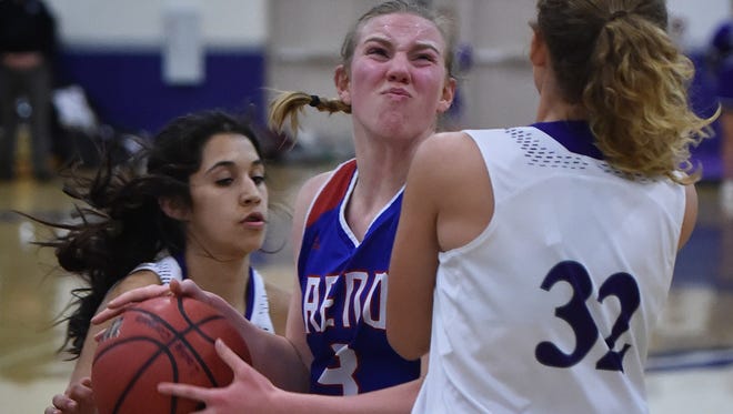 Reno's Sheridan Manfredi is covered by Spanish Springs' Naelia Pinedo, left, and Haley Morgan as she looks to shoot in the second half of Tuesday's game at Spanish Springs.