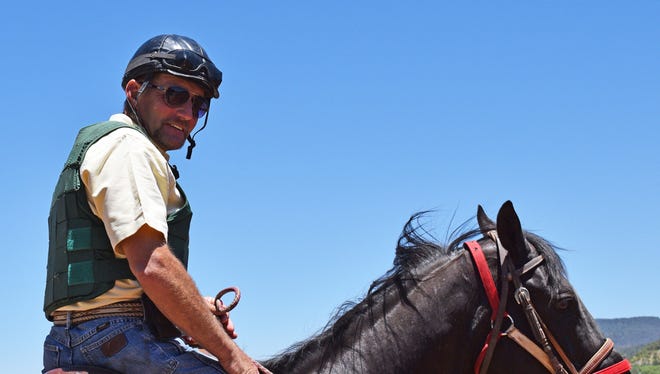 Trainer Wes Giles rides one of the horses he trains at Ruidoso Downs.