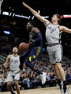 Indiana Pacers guard Victor Oladipo (4) drives to the basket past San Antonio Spurs center Pau Gasol (16) during the first half of an NBA basketball game, Sunday, Jan. 21, 2018, in San Antonio.