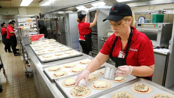 Wendy Squires assembles calzones Wednesday, October 12, 2016, at Lafayette Jeff. Lafayette School Corp. is now serving its students a menu of fresher meal options.
