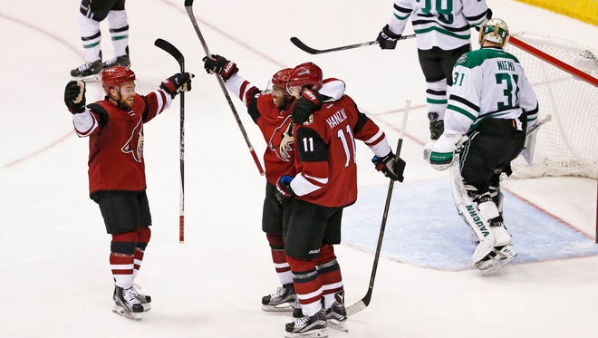 Arizona Coyotes' Max Domi (left) and Anthony Duclair celebrate a goal by Martin Hanzal (11) against the Dallas Stars in the 3rd period in Glendale, Ariz., on Thursday, February 18, 2016.