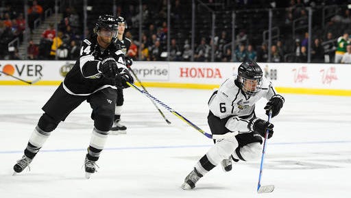 Singer Justin Bieber, right, of Team Gretzky, skates with the puck as Chris Pronger of Team Lemieux reaches in during the first period of the NHL All-Star Celebrity Shootout at Staples Center, Saturday, Jan. 28, 2017, in Los Angeles. The NHL All-Star Game is scheduled to be played at Staples Center on Sunday.