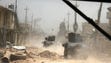 Iraqi military vehicles and troops advance towards