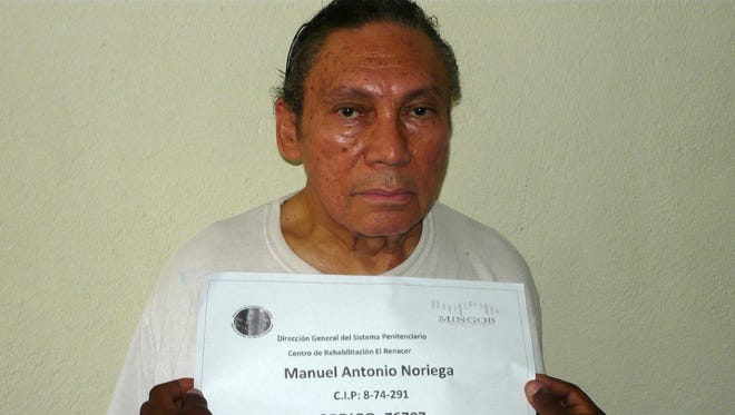 This handout picture taken  Dec. 14, 2011, shows former Panamanian  dictator Manuel Noriega having his mug shot being taken at the El Renacer penitentiary, southeast of Panama City.