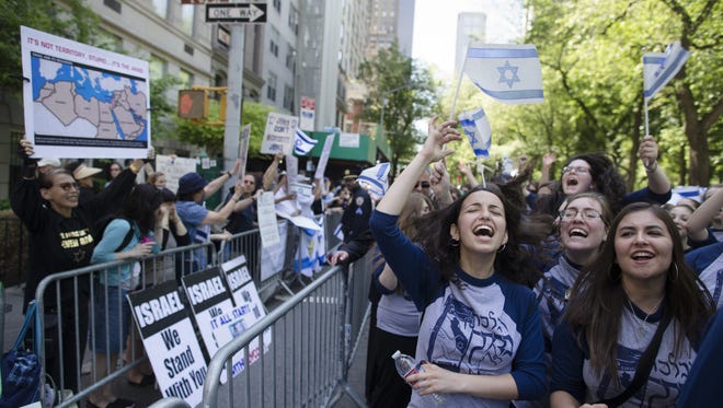 Marchers cheer as they pass along a barricade separating them from anti-Boycott, Divestment and Sanctions (BDS) movement protesters during the Celebrate Israel Parade in New York in 2014.