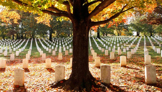 FILE - In this Oct. 28, 2010, file photo, fall leaves lay among the gravestones at Arlington National Cemetery in Arlington, Va. The cemetery gets between 3 and 4 million visitors a year.