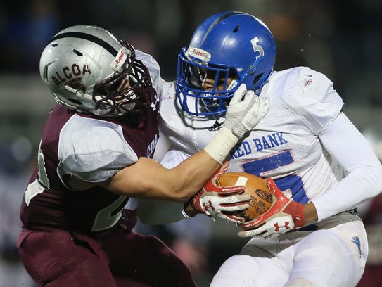 Alcoa defensive lineman Tristan Woody (left)