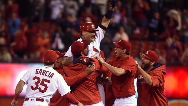 St. Louis Cardinals catcher Yadier Molina (4) celebrates after hitting a walk-off double off of Cincinnati Reds relief pitcher Blake Wood (not pictured) during the ninth inning at Busch Stadium. The Cardinals won 4-3.