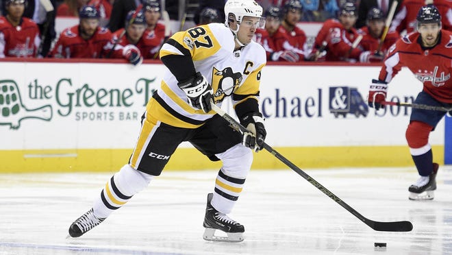 Pittsburgh Penguins center Sidney Crosby (87) skates with the puck during the second period of an NHL hockey game against the Washington Capitals, Friday, Nov. 10, 2017, in Washington. (AP Photo/Nick Wass)