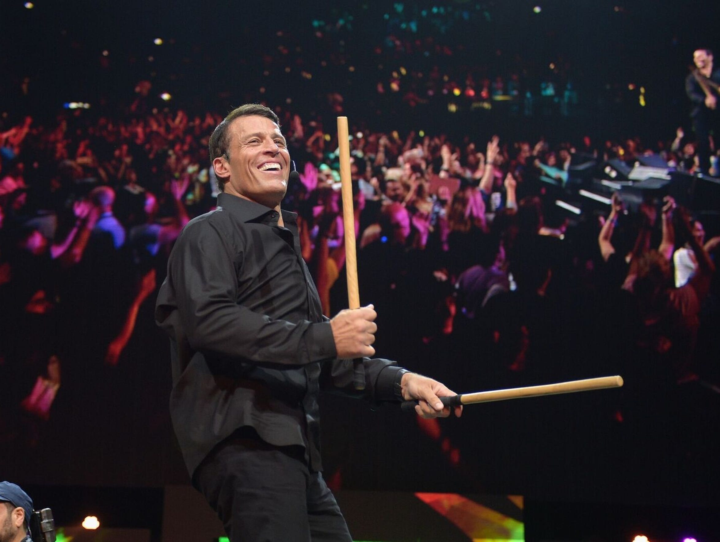 Tony Robbins bangs sticks together at the start of