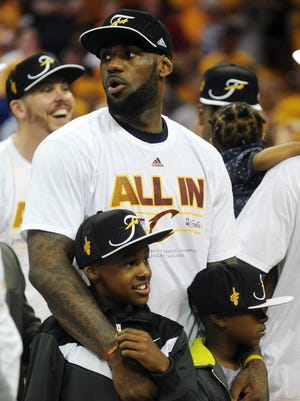 LeBron James  is shown with his sons LeBron  Jr. and Bryce Maximus  after the Cavaliers beat the Hawks in Game 4 of the NBA Eastern Conference Finals at Quicken Loans Arena.