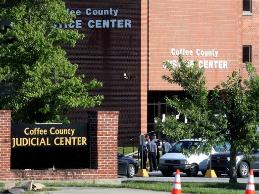 Authorities work the crime scene at the Coffee County