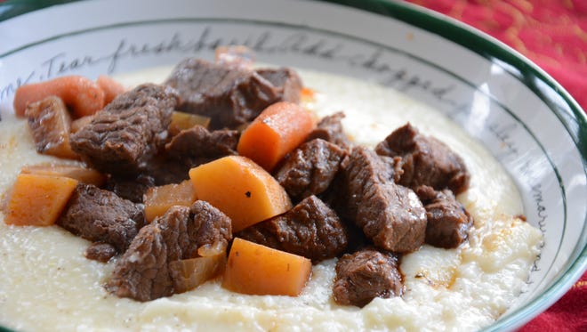 Braised Beef is served over grits or mashed potatoes.