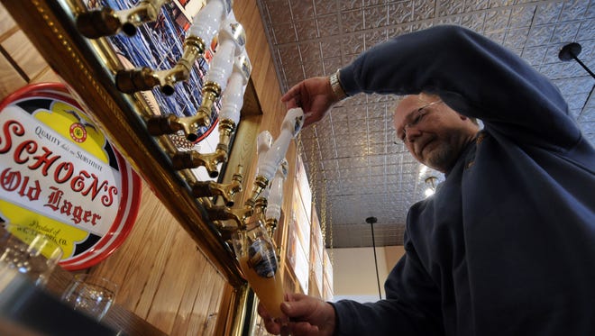 Michael Zamzow, Brewer/Owner of Bull Falls Brewery in Wausau pours a glass of one of their signature beers.