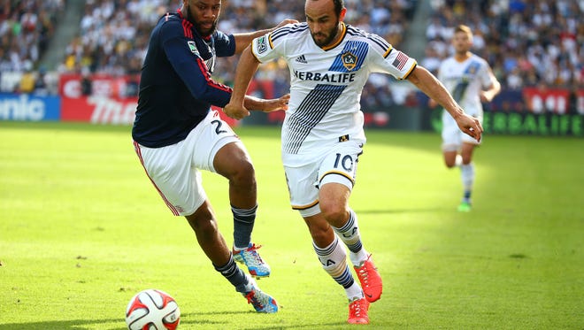 LOS ANGELES, CA - DECEMBER 07:  Landon Donovan #10 of the Los Angeles Galaxy plays the ball past Andrew Farrell #2 of the New England Revolution in the first half during the 2014 MLS Cup match at StubHub Center on December 7, 2014 in Los Angeles, California.  (Photo by Victor Decolongon/Getty Images) ORG XMIT: 526302673
