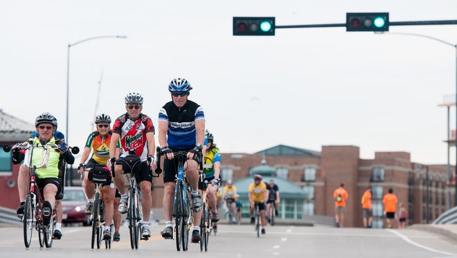 Bicyclists ride on Dousman Street during the first Open Streets Green Bay event in 2013.