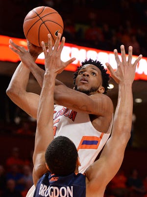 Clemson forward Jaron Blossomgame (5) scores over Virginia guard Malcolm Brogdon (15) during the 2nd half on Tuesday, March 1,  2016 at Bon Secours Wellness Arena in downtown Greenville.
