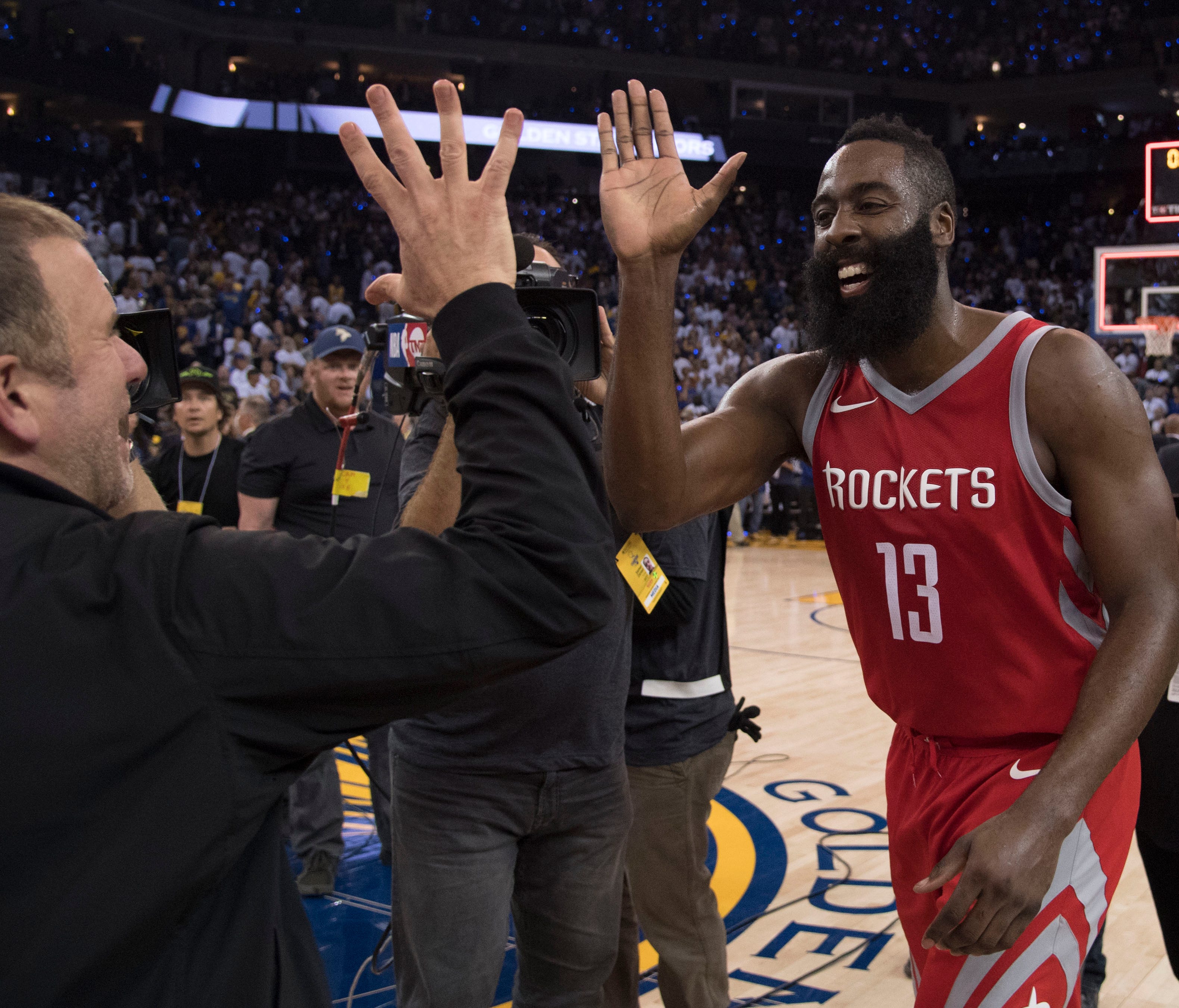 Houston Rockets owner Tilman Fertitta (left) celebrates with guard James Harden (13) after the game against the Golden State Warriors at Oracle Arena.